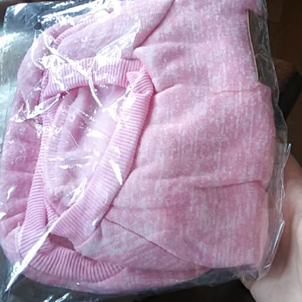 A pink classic coat/jumsuit for dogs its large